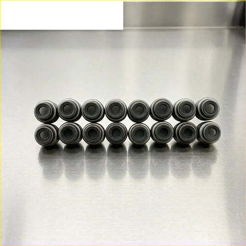 Twelve black cylindrical valve stem oil seals arranged in two rows for chrysler vista sohc mitsubishi 4g93 gasket pro