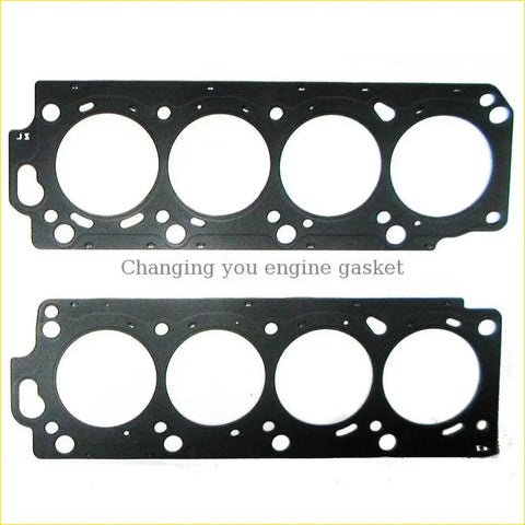 Black metal cylinder head gasket with four circular openings and textured surface for toyota land cruiser 100 or lexus lx 2uzfe