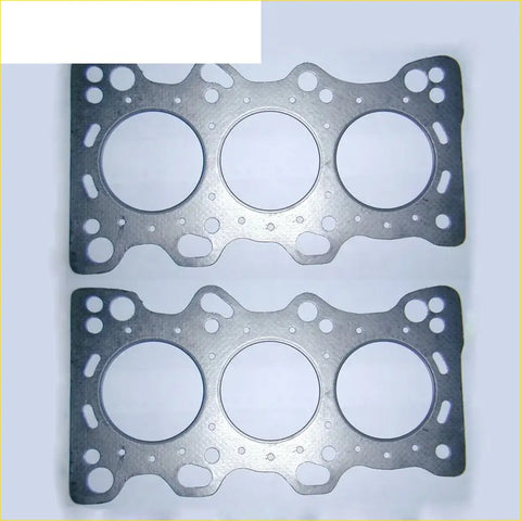 Two silver metallic cylinder head gaskets with three large openings for honda legend and rover 800 engines