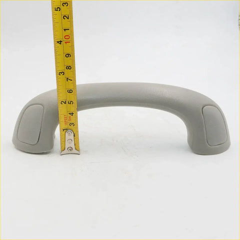 Gray plastic a-pillar grab handle for toyota hilux sr5 mk6 with rounded ends and textured grip surfaces