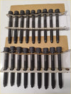 Black metal head gasket bolts with threaded shafts and hex heads arranged on cardboard tray for navara pathfinder murano nv350