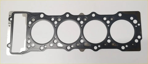 Black rubber head gasket with four circular openings and a rectangular cutout for mitsubishi canter 4m42 engine