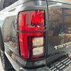 Black plastic taillight cover with red and clear lens sections for mitsubishi triton 2024+ matte finish