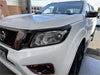White nissan navara 2021 plus sl with matte headlight and taillight covers black trim and chrome accents back view