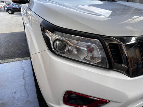 White nissan pathfinder headlight cover with chrome accents and sleek modern design for nissan navara 2021+ sl matte