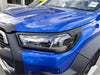 Vibrant blue toyota hilux 2025 sr5 matte headlight covers with sleek led lights and black plastic trim