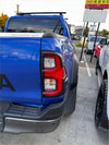 Blue 2025 toyota hilux sr5 pickup backside with matte headlight and taillight covers and black roof rack