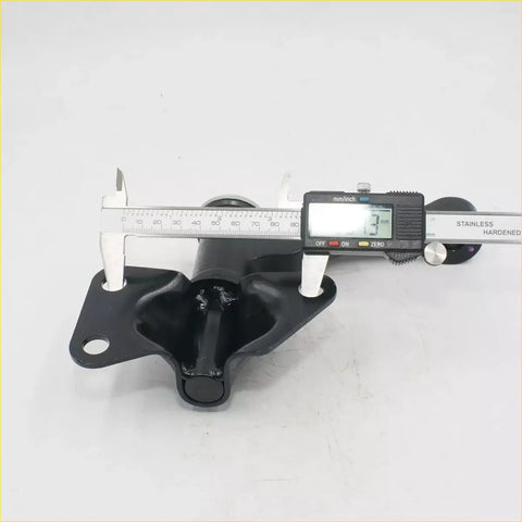 Black metal idler arm control arm measured with caliper for nissan navara ute 4wd sd22 showing backside