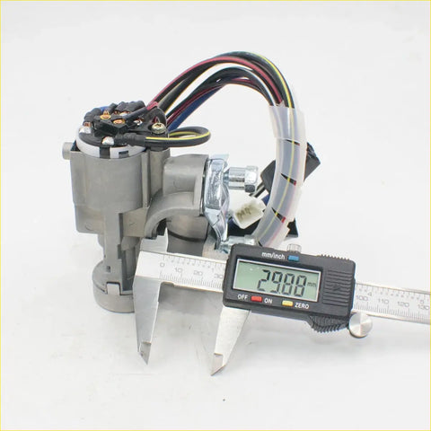 Gray metallic power window motor with colorful wiring and 29 mm digital caliper for Mazda B series ignition switch locks