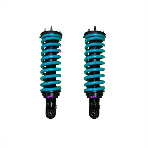 A pair of vibrant turquoise dobinsons ims monotube coil-over shocks with black and purple accents for isuzu dmax off-road use