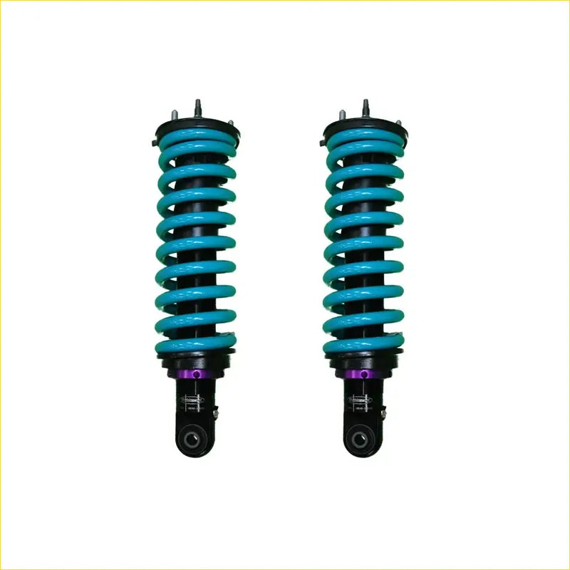 A pair of vibrant turquoise dobinsons ims monotube coil-over shocks with black and purple accents for isuzu dmax off-road use