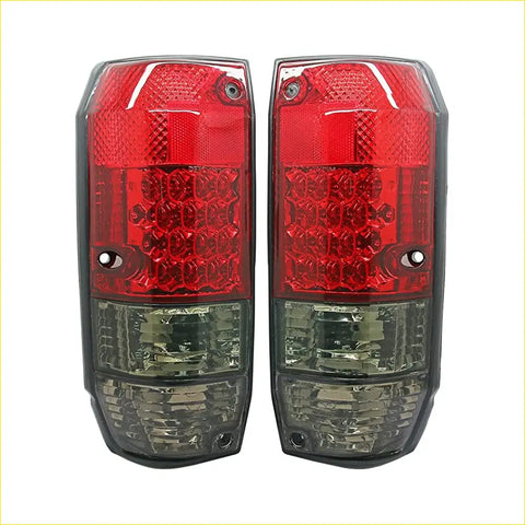 Led tail lights pair with red and clear textured lenses featuring brake and reverse light sections
