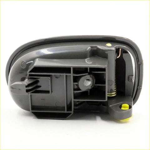 Back side of black plastic lh door handle with yellow accents for mazda familia 323 b series b2000 fd courier years