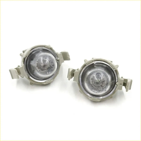 Pair of beige plastic license plate light assemblies with clear lenses and mounting brackets for toyota hilux 2004-2015