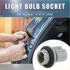 Gray plastic light bulb socket with black rubber gasket being installed in a 2013-2018 toyota rav4 door panel