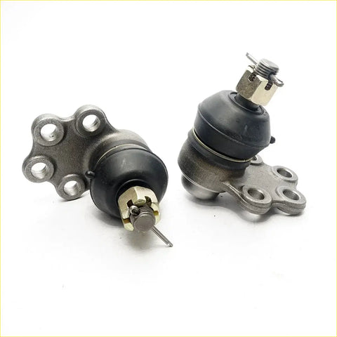 Two metallic lower ball joints with black rubber boots and brass adjustment parts for nissan datsun sunny 74-82