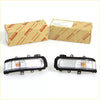 Black-framed toyota hilux mirror cover turn signal lights with clear lenses and amber indicators 2011-2015