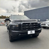 Black Mitsubishi Triton 2024+ with bold honeycomb grille and sleek LED headlights featuring Monsoon and bonnet guard style