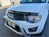White mitsubishi triton pickup truck with silver metal monsoon and bonnet guard front bumper and black grille