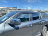 Gray metallic chevrolet silverado with chrome side mirrors and black roof rack shown with monsoon and bonnet guard for mitsubishi triton 2024+