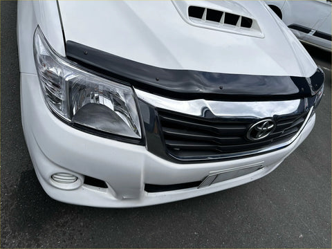 White toyota hilux with black plastic monsoon bonnet guard and chrome grille for 2012-2015 models