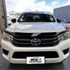 White toyota hilux pickup with black front grille and chrome emblem featuring monsoon and bonnet guard 2015-2020