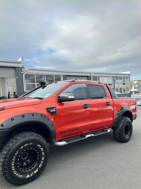 Red ford ranger px1 2012-2015 with matte black monster flare bolt style fender flares and large off-road tires