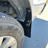Black metal fender flare with three bolts attached to wheel well for matte black mudflaps on toyota hilux 2015+