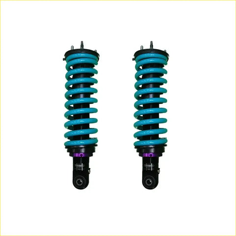 A pair of dobinsons ims monotube shock absorbers for nissan navara frontier d40 with teal coils and black bodies