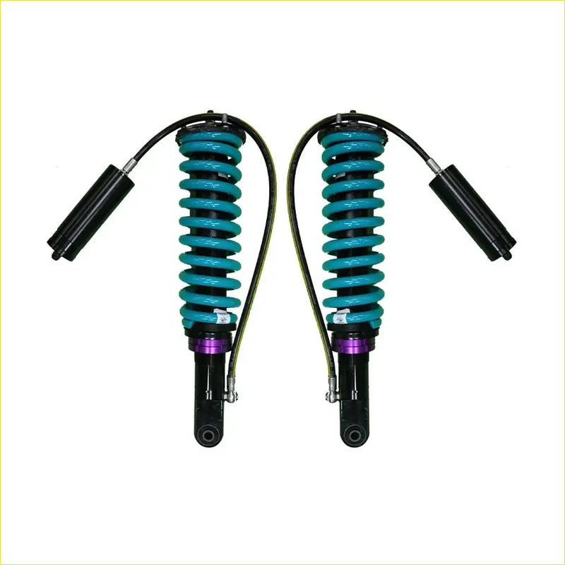 A pair of teal-coiled dobinsons monotube remote suspension shocks for nissan navara frontier d40 with black purple accents