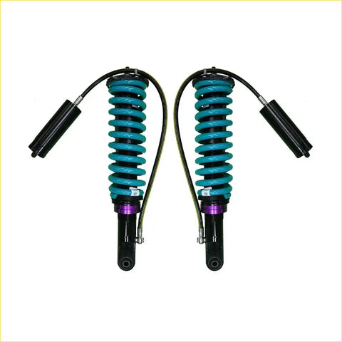 A pair of teal-coiled dobinsons monotube suspension shocks with black and purple accents for nissan navara frontier d40 stx550