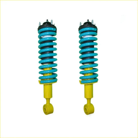 A pair of vibrant turquoise and yellow coil-over suspension shocks with black top mounts for nissan pathfinder r51 ti 550 diesel 3.0l tdi 2010 to 2013