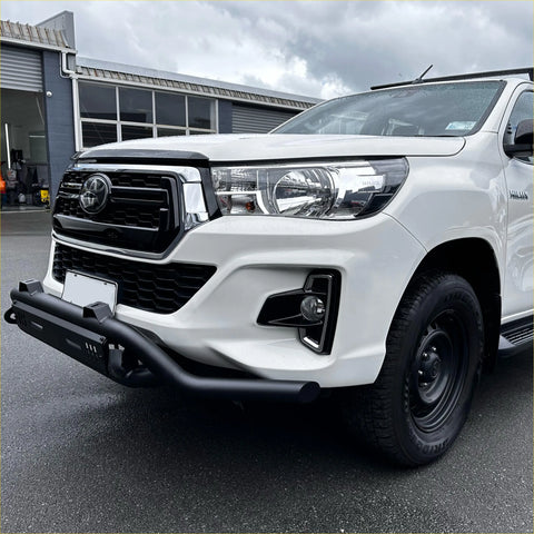 White toyota hilux with lower style black nudge bar compatible with front camera and sensors and chrome accents