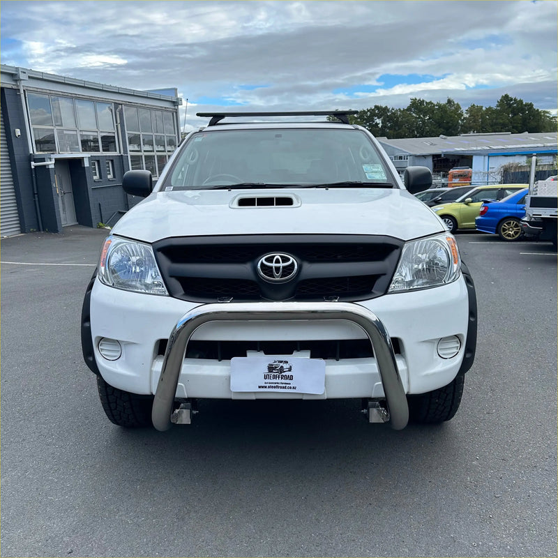 White toyota hilux with a chrome nudge bar compatible with front sensors and black grille for 2005-2015 models