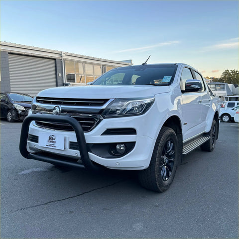 White holden colorado pickup with matte black nudge bar and black alloy wheels showing front bull bar