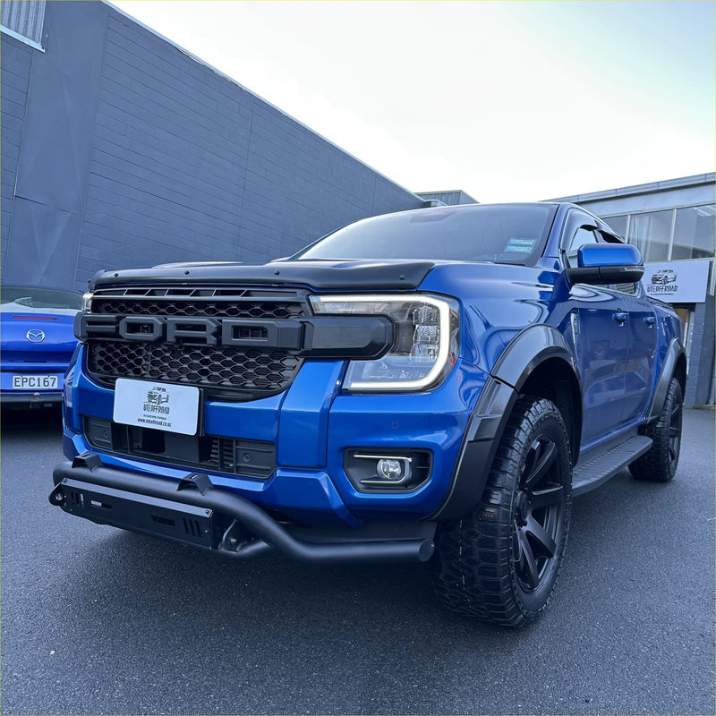 Vibrant blue ford ranger raptor with black nudge bar lower style and rugged off-road tires for ford ranger 2022+