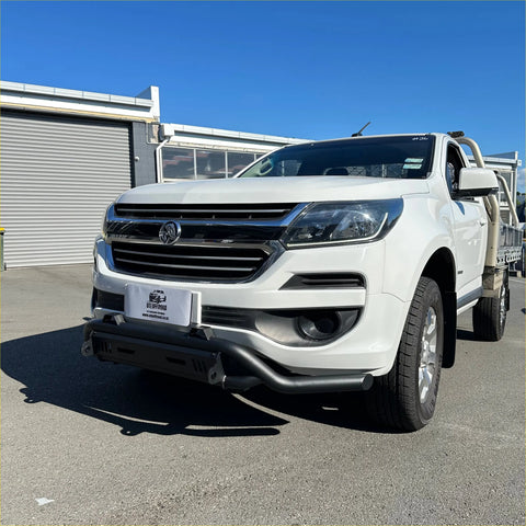 White holden colorado pickup truck with chrome grille and black front bumper featuring a nudge bar lower style
