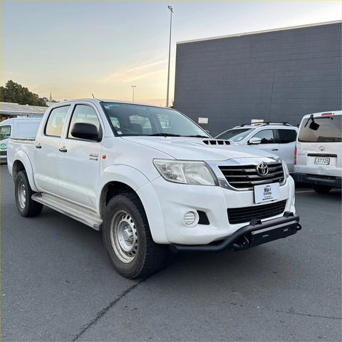 White toyota hilux vigo 2012-2015 with black nudge bar lower style bumper guard and silver side steps visible
