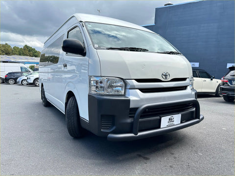 White toyota hiace van with black front bumper and mirrors featuring matte black nudge bar for wide body 2005-2019 model