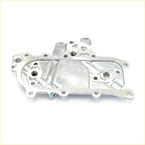 Silver metallic oil cooler cover with machined surfaces and bolt holes for nissan datsun d21 king cab 2.3l back side