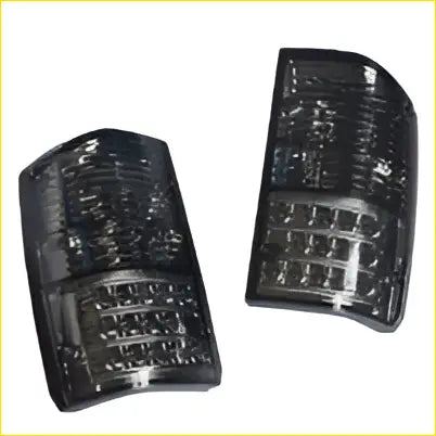 Pair smoked black led tail light assemblies with grid pattern and curved housing fit nissan patrol gq 1&2 series back view