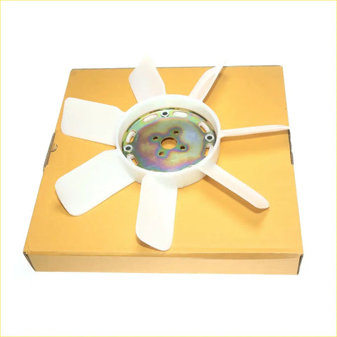 White plastic radiator cooling fan blade with metallic hub resting on orange box for nissan datsun 720 king cab