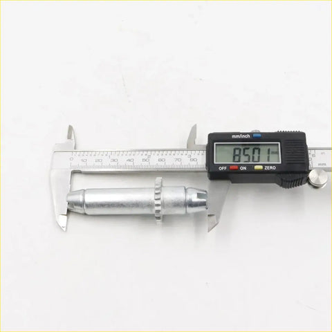Silver metallic cylindrical rear drum brake shoes adjuster bolt with hex head and digital caliper measurement for nissan d21