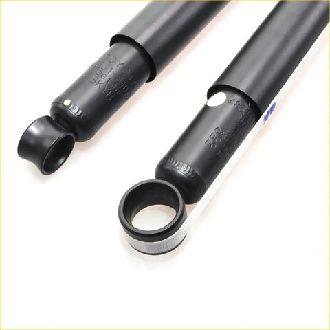 Rear black toyota hilux shock absorber with engraved model numbers and a silver metallic ring at the base