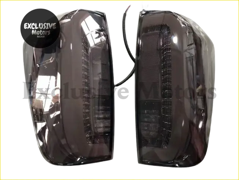 Dark smoked-tinted led rear tail light assemblies with sleek curved design for nissan navara np300 2015-2022 back view