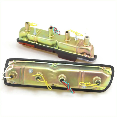Two metallic gold finished rear tail lights with black trim and wiring for datsun nissan 610 620 ute back side
