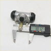 Rear wheel brake cylinder for nissan 720 d21 navara silver metal with black rubber caps and brass piston rod shown from back side