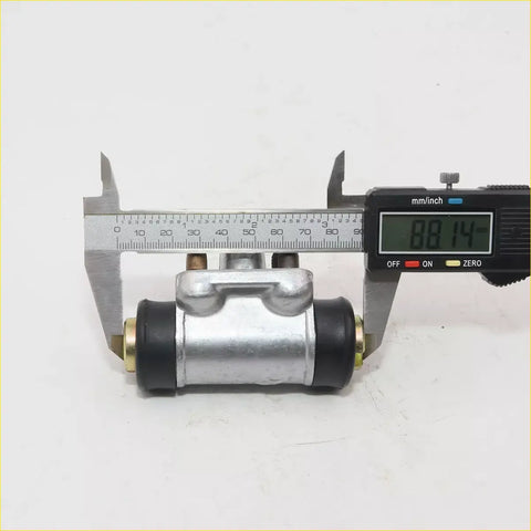 Silver rear wheel brake cylinder for Nissan 720 with black rubber boots brass fittings measured at 88.14 mm