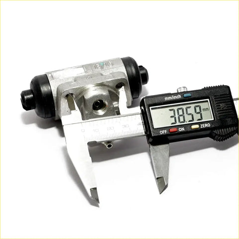 Rear wheel brake cylinder set for nissan violet with silver black brake drum and caliper showing 38.59 mm width