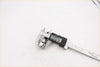 Digital caliper with black and silver body measuring 24.16 mm on stainless steel scale for rear wheel nut chrome toyota hilux